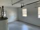 Clean and empty garage with gray painted floor and white walls at 2078 Keyes Ln, Deltona, FL 32738