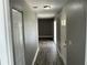 Inviting hallway with wood-look flooring, fresh paint, and ample natural light leading to living areas at 2078 Keyes Ln, Deltona, FL 32738