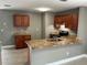 Kitchen features granite countertops, wood cabinets, stainless steel appliances, and a breakfast bar at 2078 Keyes Ln, Deltona, FL 32738