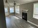 Cozy living room featuring a fireplace, modern ceiling fan, and natural light from multiple windows at 2078 Keyes Ln, Deltona, FL 32738
