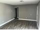 Open living room with wood-look floors and fresh paint, offering versatile living space at 2078 Keyes Ln, Deltona, FL 32738