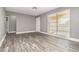 Bright living room featuring gray walls, modern floors, and sliding glass doors with vertical blinds at 2078 Keyes Ln, Deltona, FL 32738