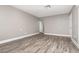 Spacious living room showcasing wood-look flooring and access to other rooms at 2078 Keyes Ln, Deltona, FL 32738