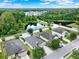 Aerial view of a community featuring single Gathering homes with lush trees and ponds, near a tranquil wooded area at 2216 Sequoia Way, Davenport, FL 33896