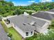 An aerial view of a charming single Gathering home featuring a well-manicured lawn and screened patio at 2216 Sequoia Way, Davenport, FL 33896