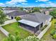 A well-maintained yard with a screen enclosed patio and white vinyl fence offering privacy and outdoor enjoyment at 2216 Sequoia Way, Davenport, FL 33896