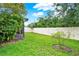 Manicured backyard with well-maintained grass and a pristine white fence at 2216 Sequoia Way, Davenport, FL 33896