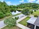 An aerial view showcases a well-maintained backyard with a screened-in patio and a charming white vinyl fence at 2216 Sequoia Way, Davenport, FL 33896