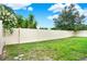 Fully fenced in backyard with lush green grass and flourishing trees at 2216 Sequoia Way, Davenport, FL 33896