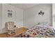 Bright bedroom featuring hardwood floors and a cozy reading nook with a glider chair at 2216 Sequoia Way, Davenport, FL 33896
