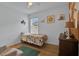 A cozy bedroom with wood flooring, bright natural light, and fun wall decor at 2216 Sequoia Way, Davenport, FL 33896