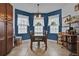 Bright dining area features wainscoting, tile floors, and a modern light fixture above the table at 2216 Sequoia Way, Davenport, FL 33896