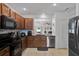 Modern kitchen with stainless steel appliances, granite countertops, and tiled backsplash at 2216 Sequoia Way, Davenport, FL 33896