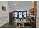 Open kitchen layout featuring granite countertops, modern appliances, and a cozy dining area at 2216 Sequoia Way, Davenport, FL 33896
