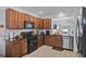 Modern kitchen with stainless steel appliances, granite countertops, and tiled backsplash at 2216 Sequoia Way, Davenport, FL 33896