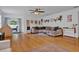 Sun-filled living room featuring light bamboo floors and a large sectional sofa at 2216 Sequoia Way, Davenport, FL 33896