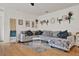 Bright living room showcasing a large gray sectional, bamboo flooring and neutral decor at 2216 Sequoia Way, Davenport, FL 33896
