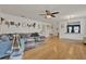 Open concept living room featuring wood floors, a ceiling fan and white walls at 2216 Sequoia Way, Davenport, FL 33896