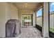 Covered patio with brick flooring and sliding glass doors leading to the home's interior at 2216 Sequoia Way, Davenport, FL 33896