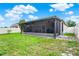 Exterior view of the home's screened-in patio and well-maintained backyard at 2216 Sequoia Way, Davenport, FL 33896