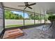 Enclosed patio featuring brick flooring, ceiling fans, and a beautiful view of the backyard at 2216 Sequoia Way, Davenport, FL 33896