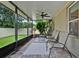 Screened in lanai with comfortable seating and backyard views at 2216 Sequoia Way, Davenport, FL 33896