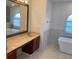 Bathroom featuring double sinks, soaking tub, with natural stone floor and wall tiles at 2299 Rock Dr, Poinciana, FL 34759