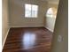 Bedroom featuring hardwood floors and two windows at 2299 Rock Dr, Poinciana, FL 34759
