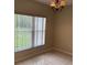 A cozy dining room with tile floors, natural light, and an elegant chandelier at 2299 Rock Dr, Poinciana, FL 34759