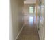 Hallway features tile flooring that leads to a bright living space at 2299 Rock Dr, Poinciana, FL 34759