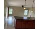 Open concept living room featuring modern lighting and a kitchen island with a dual sink at 2299 Rock Dr, Poinciana, FL 34759