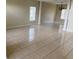 Spacious living room with tile flooring, columns, neutral walls, and natural light at 2299 Rock Dr, Poinciana, FL 34759
