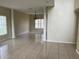 Bright living room featuring tile floors, decorative columns, and a chandelier at 2299 Rock Dr, Poinciana, FL 34759
