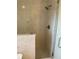 Walk in shower with glass doors and marble tile at 2299 Rock Dr, Poinciana, FL 34759