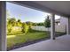 View of the spacious backyard from the covered patio, enhanced by green grass and privacy fence at 2354 Emerald Springs Dr, Apopka, FL 32712