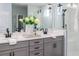 Elegant bathroom featuring double sinks, modern fixtures, and a glass-enclosed shower creating a luxurious experience at 2354 Emerald Springs Dr, Apopka, FL 32712