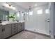 Modern bathroom featuring dual sinks, a glass-enclosed shower, and neutral tones creating a spa-like ambiance at 2354 Emerald Springs Dr, Apopka, FL 32712