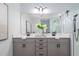 Contemporary bathroom featuring a double vanity, a walk-in shower, and modern lighting, perfect for a stylish home at 2354 Emerald Springs Dr, Apopka, FL 32712