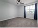 Bright bedroom featuring a large window, neutral walls, and plush carpeting, creating a serene and relaxing atmosphere at 2354 Emerald Springs Dr, Apopka, FL 32712