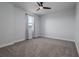 Bedroom with a ceiling fan, neutral paint, window with grey curtains, and new carpet at 2354 Emerald Springs Dr, Apopka, FL 32712