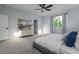 Bright bedroom featuring a gray bed, neutral carpet, and a white dresser beneath a decorative painting at 2354 Emerald Springs Dr, Apopka, FL 32712