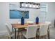 Dining room with rustic wood table, modern chandelier, and blue decorative vases at 2354 Emerald Springs Dr, Apopka, FL 32712