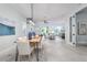 Bright dining room with wood table, pendant lighting, and view of living area at 2354 Emerald Springs Dr, Apopka, FL 32712