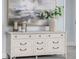 Stylish dresser with decorative accents, gold hardware, and a serene decorative display atop, enhancing the room's elegance at 2354 Emerald Springs Dr, Apopka, FL 32712