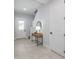 Bright foyer featuring tile flooring, a stylish console table with a lamp, and a staircase at 2354 Emerald Springs Dr, Apopka, FL 32712