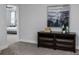 Well-lit hallway showcasing a dark wood dresser and access to a bedroom with neutral paint and carpet at 2354 Emerald Springs Dr, Apopka, FL 32712