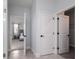 Hallway with tile flooring and open doors to a bedroom, bathroom and closet at 2354 Emerald Springs Dr, Apopka, FL 32712