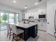 Bright kitchen featuring a large island, stainless appliances, and white cabinetry at 2354 Emerald Springs Dr, Apopka, FL 32712