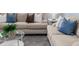 Inviting living room area with plush beige sofas, decorative pillows, and a stylish glass coffee table at 2354 Emerald Springs Dr, Apopka, FL 32712