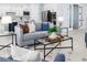 Open-concept living room showcasing modern furniture, natural light, and seamless flow to kitchen at 2354 Emerald Springs Dr, Apopka, FL 32712
